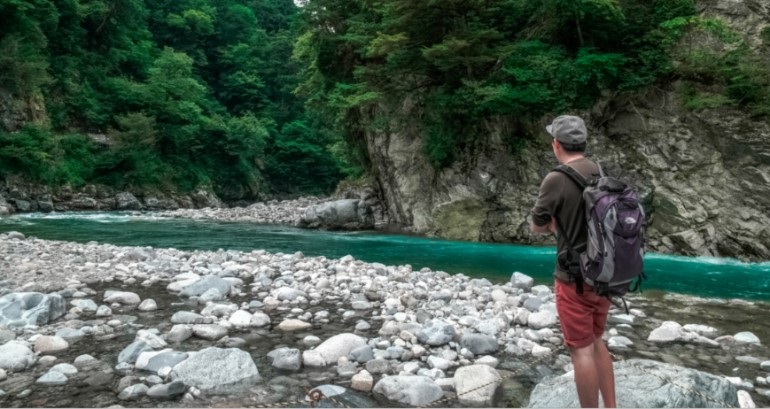 Backpacker by a river